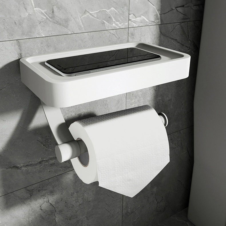Wall-mounted toilet roll holder with shelf in a grey marble bathroom